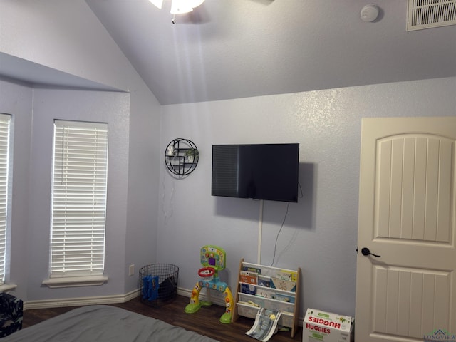 bedroom featuring wood finished floors, visible vents, baseboards, ceiling fan, and vaulted ceiling