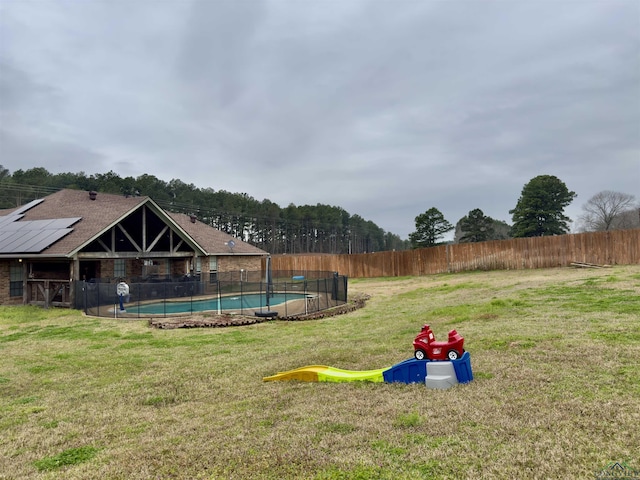 view of yard featuring a fenced in pool and fence