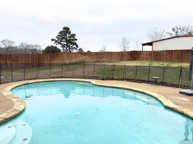 view of swimming pool with a fenced in pool, a yard, and fence