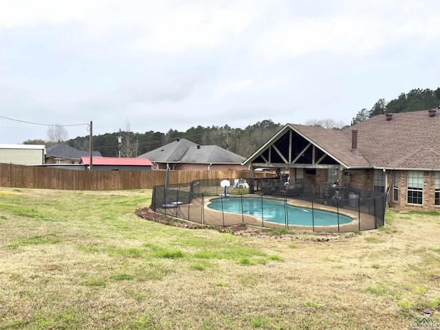 view of pool with a lawn, a fenced backyard, and a fenced in pool