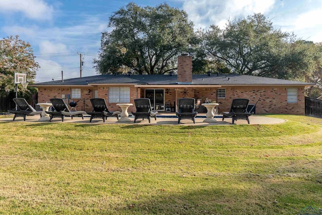 back of house featuring a yard and a patio