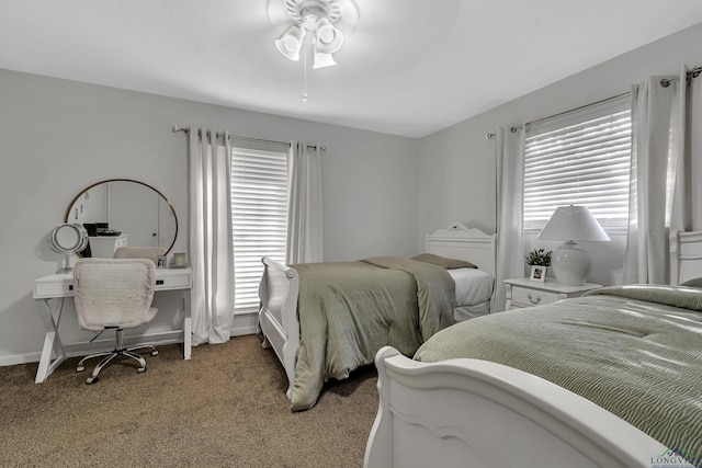 bedroom with carpet flooring, ceiling fan, and multiple windows