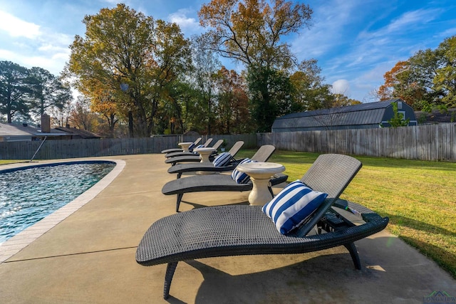 view of swimming pool with a lawn and a patio