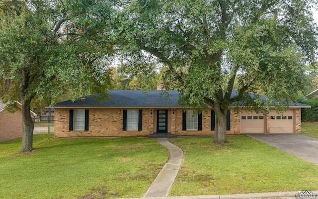 ranch-style home featuring a garage and a front lawn