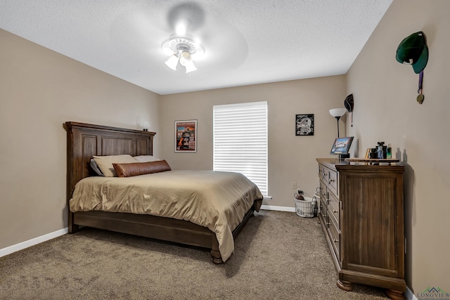 carpeted bedroom featuring ceiling fan and a textured ceiling