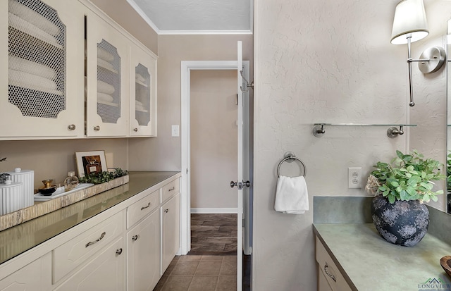 bathroom with tile patterned flooring, vanity, and ornamental molding