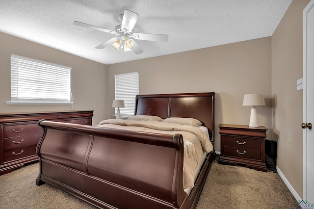 bedroom with a textured ceiling, light colored carpet, and ceiling fan