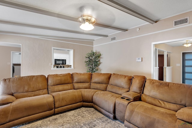 living room with beamed ceiling and a textured ceiling