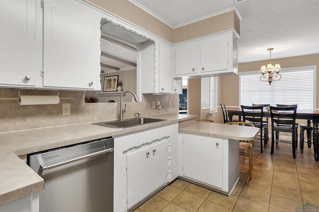 kitchen featuring pendant lighting, dishwasher, white cabinets, sink, and kitchen peninsula