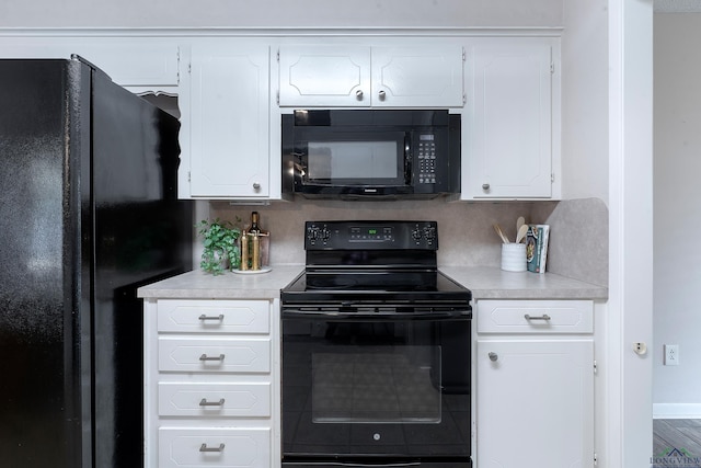 kitchen featuring black appliances, white cabinets, and backsplash