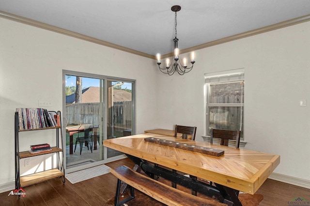 dining space featuring ornamental molding, dark wood-type flooring, and an inviting chandelier