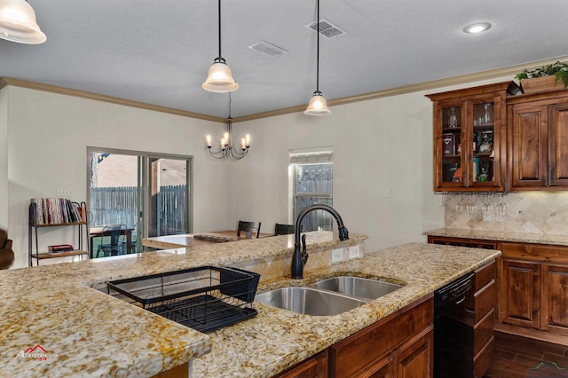 kitchen with light stone countertops, dishwasher, decorative light fixtures, and a notable chandelier