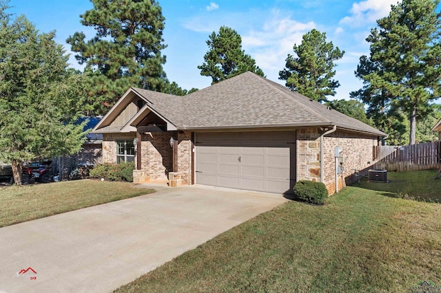 view of front facade with a garage, a front lawn, and central air condition unit