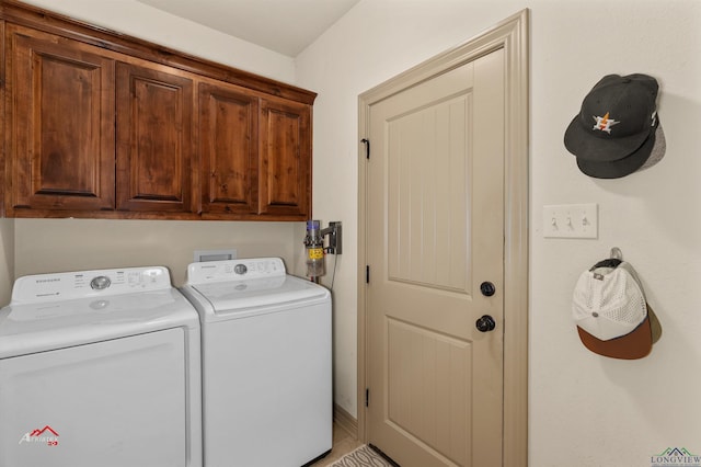 washroom featuring washer and dryer and cabinets