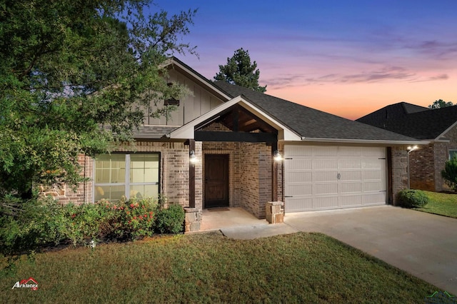 view of front of home with a garage and a yard