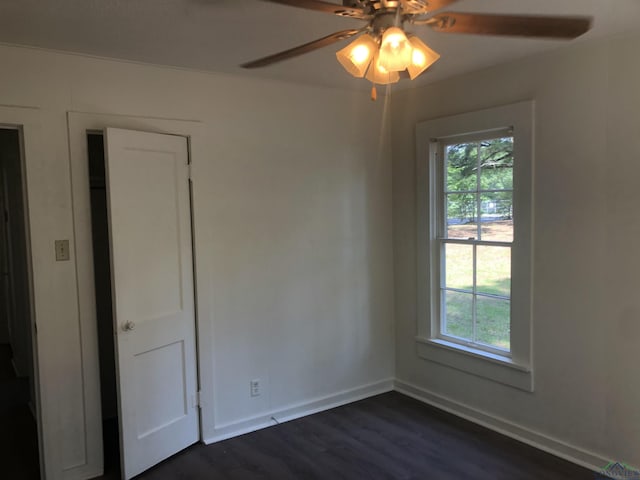 602 Premier Rd, Longview, TX 75604 - unfurnished room featuring plenty of natural light, ceiling fan, dark wood-style flooring, and baseboards