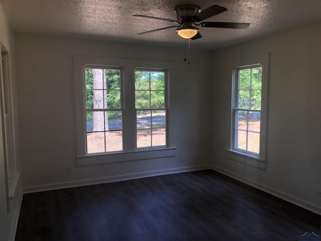 602 Premier Rd, Longview, TX 75604 - spare room featuring a textured ceiling, dark wood-type flooring, baseboards, and ceiling fan