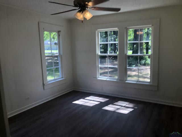 602 Premier Rd, Longview, TX 75604 - unfurnished room featuring dark wood-style floors, ceiling fan, and baseboards
