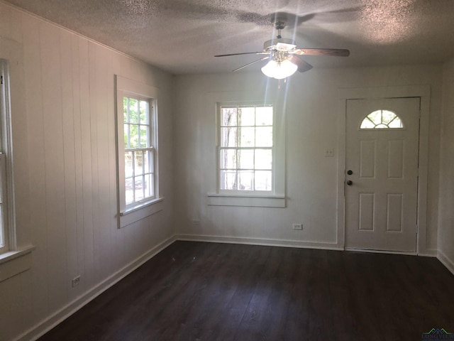602 Premier Rd, Longview, TX 75604 - foyer entrance featuring a textured ceiling, dark wood finished floors, healthy amount of natural light, ceiling fan, and baseboards