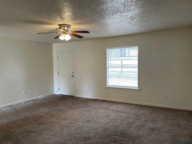 carpeted spare room with ceiling fan, a textured ceiling, and ornamental molding