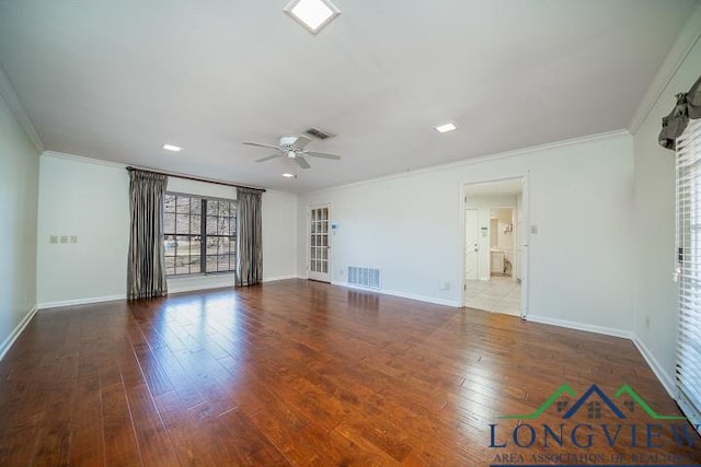 unfurnished room with hardwood / wood-style floors, ceiling fan, and crown molding