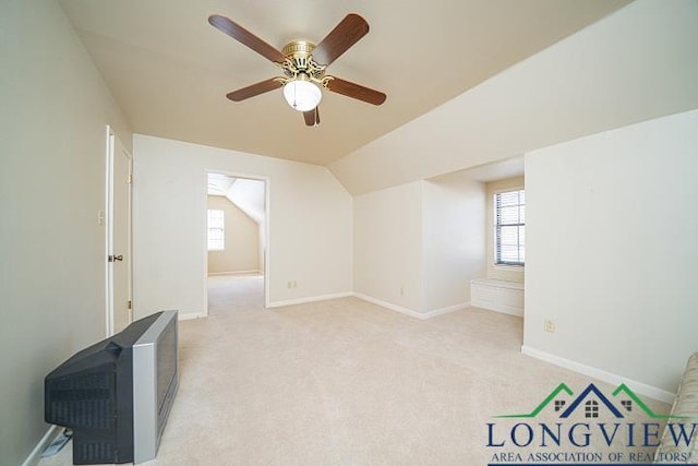 additional living space featuring ceiling fan, light carpet, and vaulted ceiling