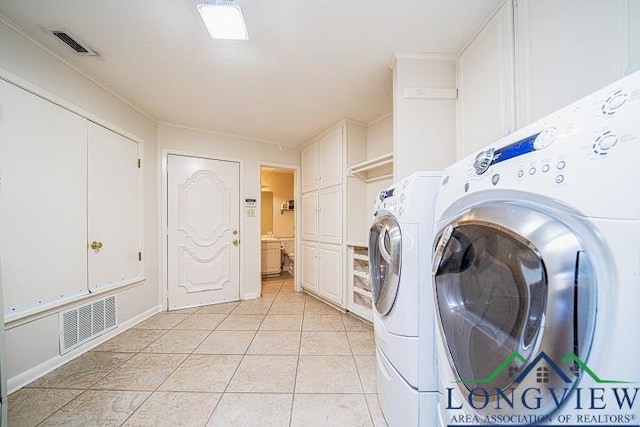 laundry area featuring independent washer and dryer and light tile patterned floors