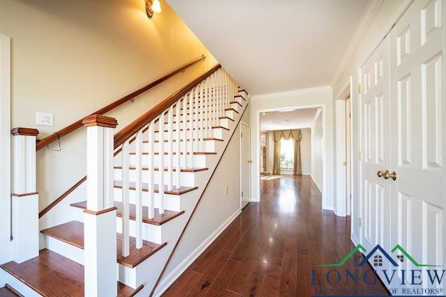 stairway with hardwood / wood-style floors and crown molding