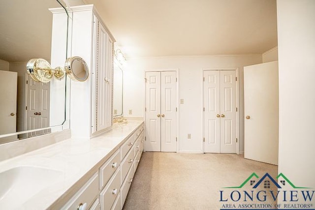 bathroom featuring vanity and crown molding