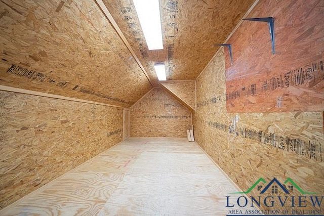 additional living space featuring lofted ceiling