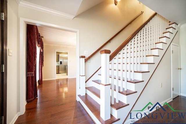 staircase featuring hardwood / wood-style flooring and ornamental molding