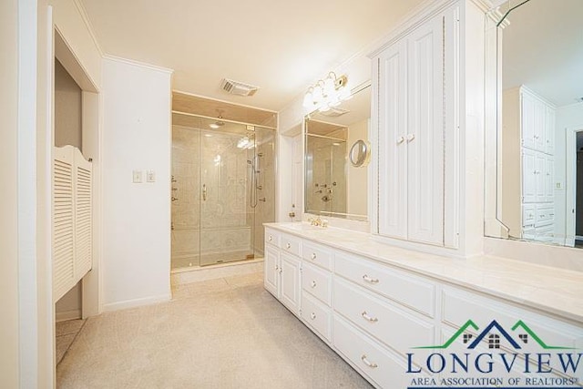 bathroom with vanity and a shower with door