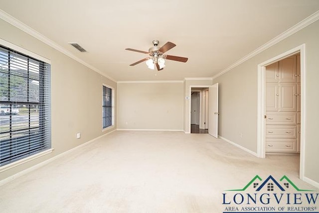 interior space featuring ceiling fan, crown molding, and light carpet