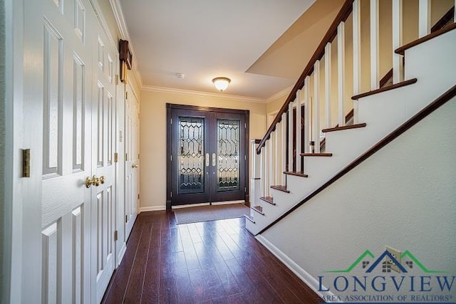 entrance foyer featuring dark hardwood / wood-style flooring, a wealth of natural light, and crown molding