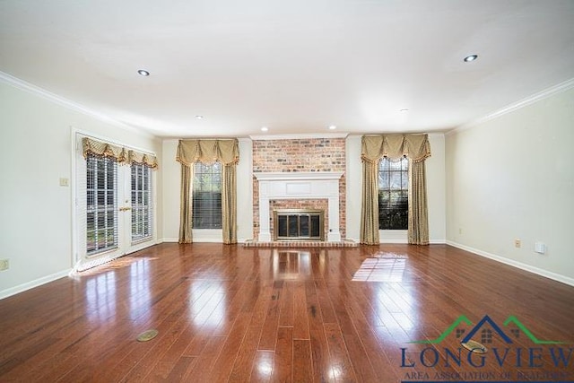 unfurnished living room with a fireplace, wood-type flooring, and crown molding