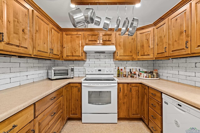 kitchen featuring tasteful backsplash and white appliances