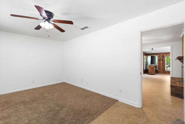 empty room featuring carpet floors and ceiling fan