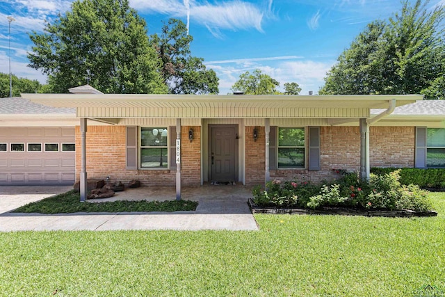 single story home with a front yard, a porch, and a garage