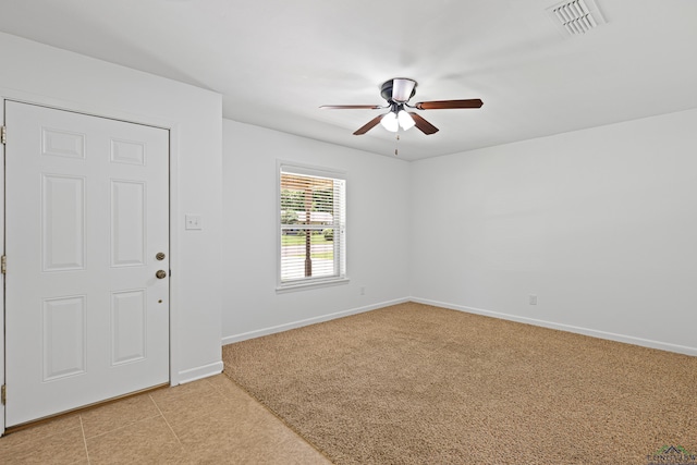 entrance foyer with ceiling fan and light colored carpet