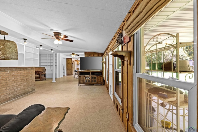 living room featuring vaulted ceiling and ceiling fan