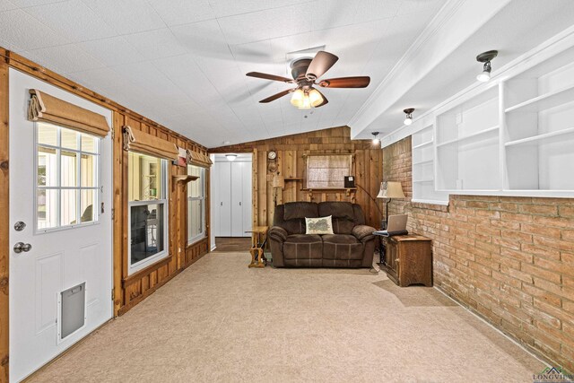 living room with wooden walls, carpet floors, brick wall, and vaulted ceiling