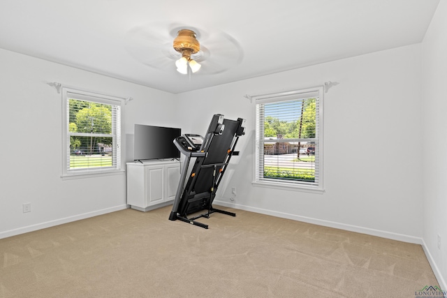 workout room with light colored carpet and ceiling fan