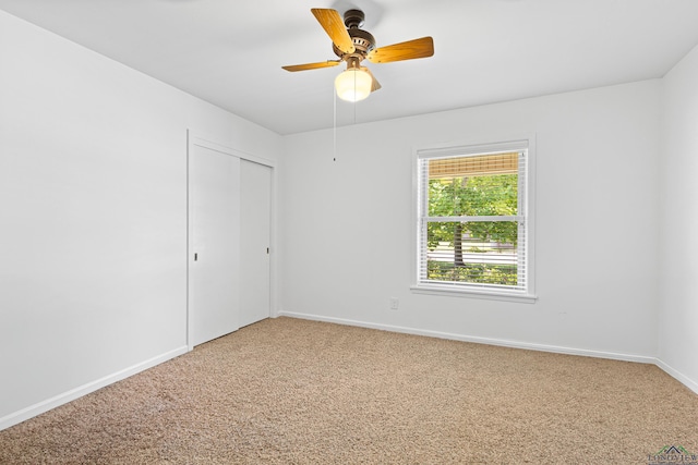 unfurnished room featuring ceiling fan and carpet floors