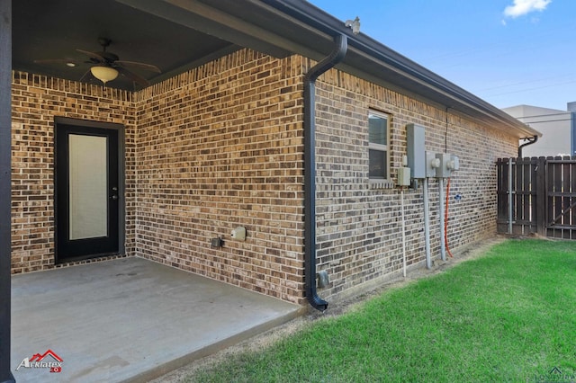 view of side of property with ceiling fan and a patio