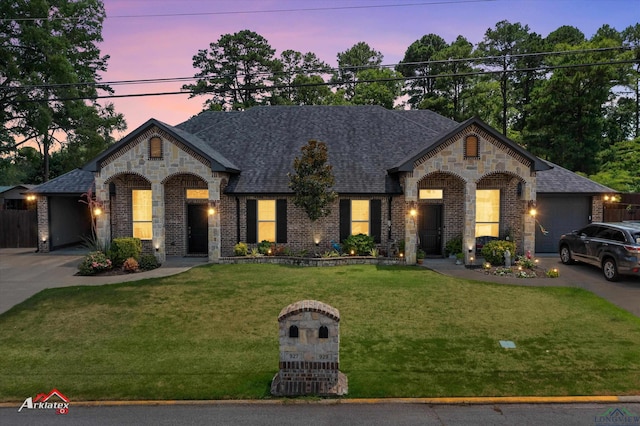 french country style house featuring a lawn