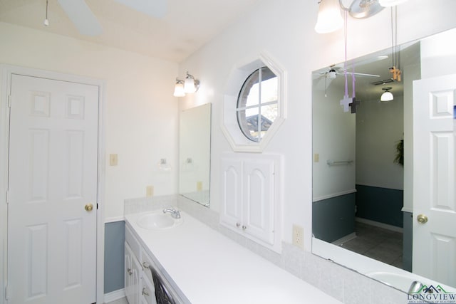 bathroom with ceiling fan, tile patterned flooring, and vanity