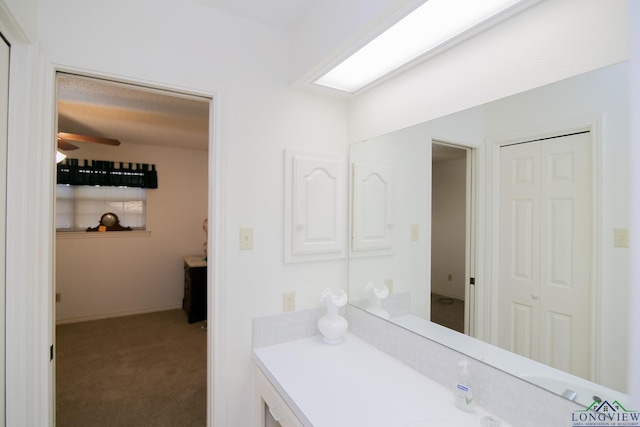 bathroom with ceiling fan and vanity