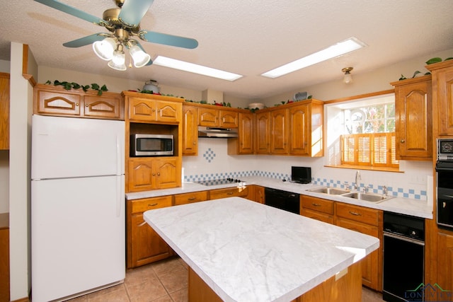 kitchen with a center island, black appliances, sink, decorative backsplash, and light tile patterned floors