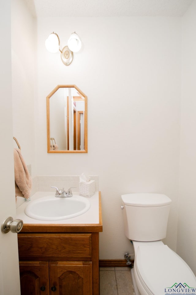 bathroom with tile patterned floors, vanity, and toilet