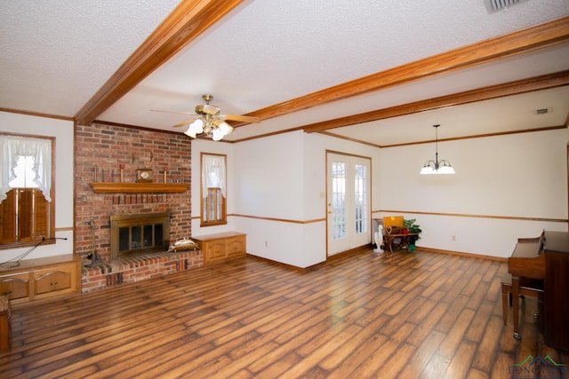 living room with a fireplace, ceiling fan with notable chandelier, a healthy amount of sunlight, and dark hardwood / wood-style floors